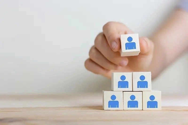 woman placing cube in pile