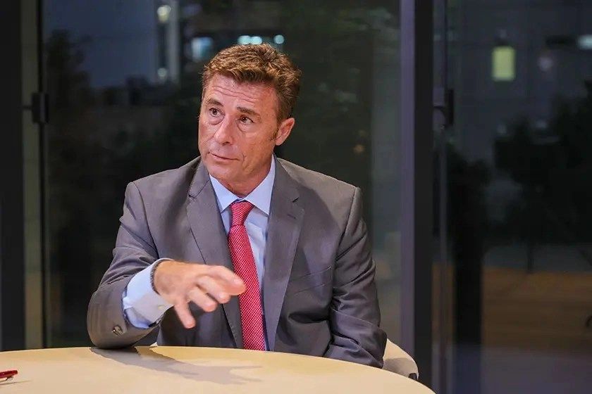 a man in a suit sitting at a table