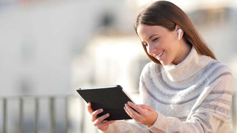 A woman using tablet happy with her customer experience