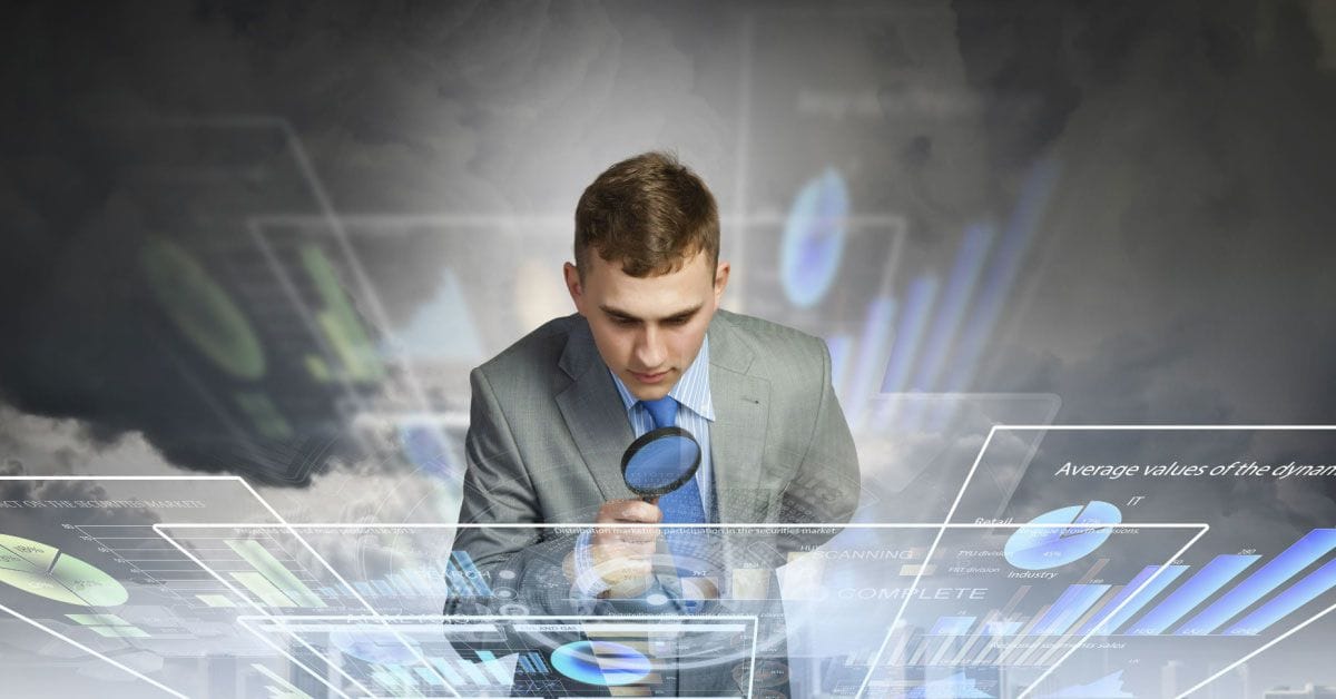 Businessman examining objects with magnifier