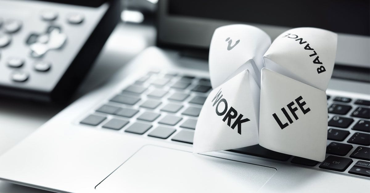 Origami fortune teller on laptop in office concept for work life balance choices