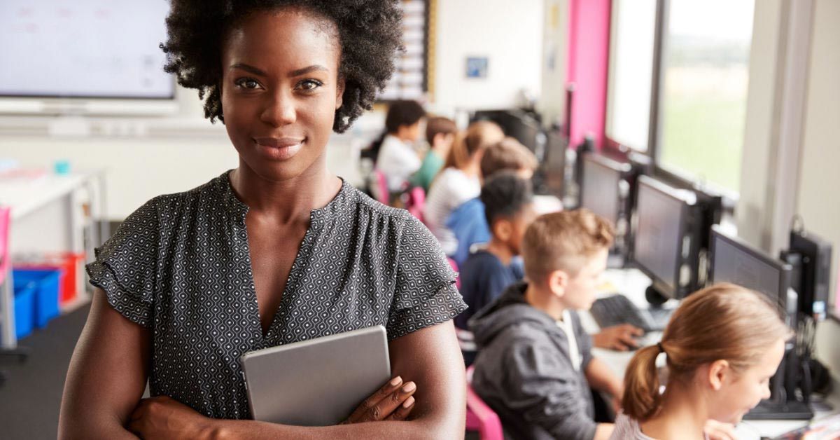 Female teacher holding digital tablet